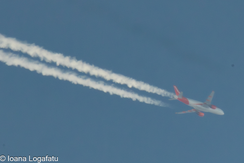 Airplane soaring through a clear blue sky